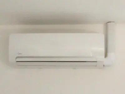 a white air conditioner hanging from a ceiling at HouseBoat next to AMSTEL in Amsterdam