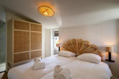 a bedroom with a large white bed with towels on it at Buiten aan zee by Droomvilla in Sint Maarten
