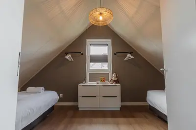 a room with two beds and a sink in a attic at Modern Sint Maarten by Droomvilla in Sint Maarten