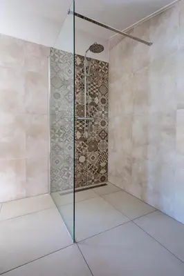 a shower with a glass door in a bathroom at Hip in Sint Maarten by Droomvilla in Sint Maarten