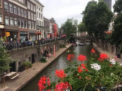 a view of a canal with flowers and buildings at Wellness Suite Utrecht in Utrecht