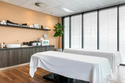 a room with a white table in front of a counter at Corendon Amsterdam Schiphol Airport, a Tribute Portfolio Hotel in Badhoevedorp