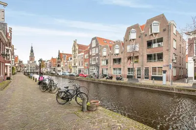 a group of bikes parked on the side of a canal at Lovely City Center Apartment in Alkmaar