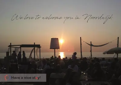 a crowd of people watching a stage with the sunset at Have a nice stay! - Paris Plage - volledig vernieuwd, free parking in Noordwijk aan Zee