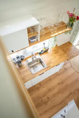 an overhead view of a kitchen with a sink at Green Tiny House with shared pool in Zeewolde