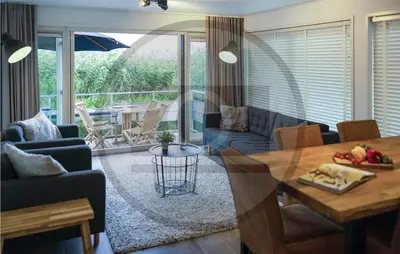 a living room with a table and a dining room at Amazing Ship In Aalsmeer in Aalsmeer