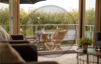 a patio with a table and chairs on a balcony at Amazing Ship In Aalsmeer in Aalsmeer