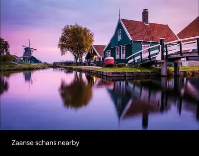 a house and a windmill next to a river at Wellness bungalow with jacuzzi &sauna&private garden near Amsterdam in Vijfhuizen