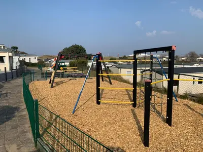 a group of swings in a playground at Tiny House in de duinen van IJmuiden aan Zee in IJmuiden