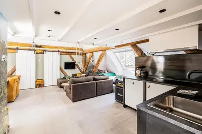 a kitchen and living room in a house at Authentic apartment in farmhouse near Amsterdam in Ilpendam