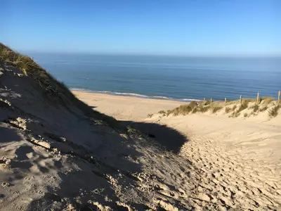 a sandy beach with the ocean in the background at De Duinlopers - Studio appt Bries - Strand, duinen en nabij cultuur steden in Castricum
